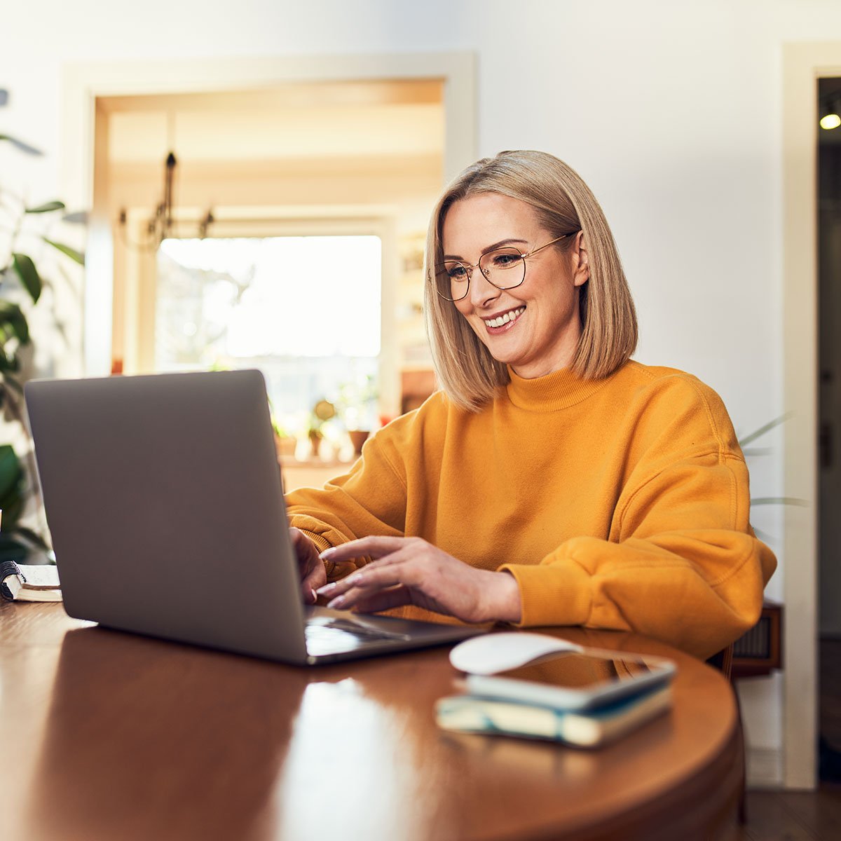 Woman on computer after signing up for a first time homebuyer savings account with PCU