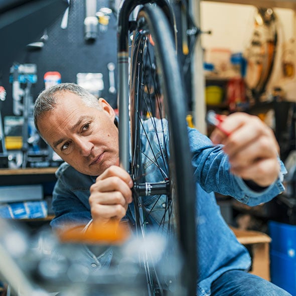 Small business bike repair shop uses a PCU Business Savings Account to save for a rainy day.