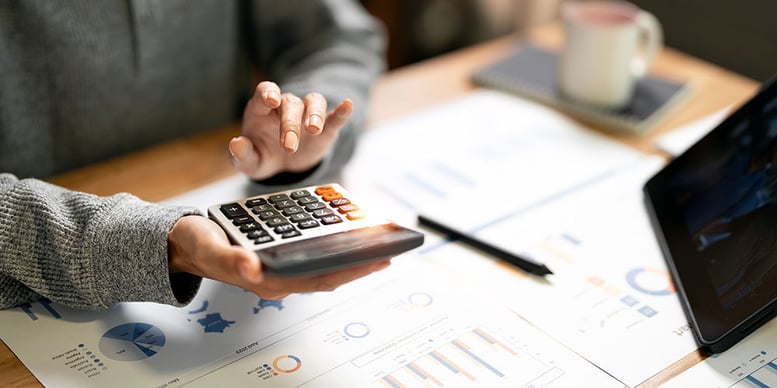 Woman making calculations for her business taxes.