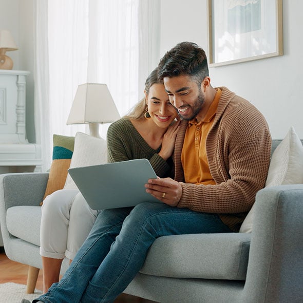 Couple retirement planning together on the couch.