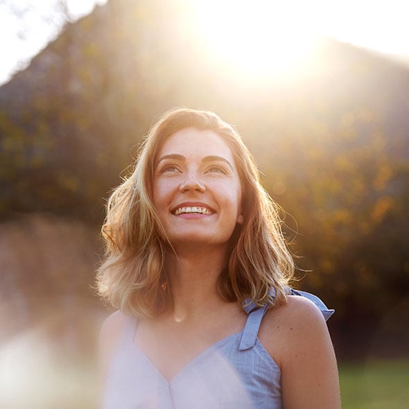 A happy and peaceful woman enjoys financial peace because she is improving her credit score.