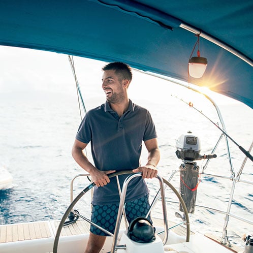 Man on his boat who is saving and growing money with a certificate of deposit savings account with PCU credit union in Portland Oregon.