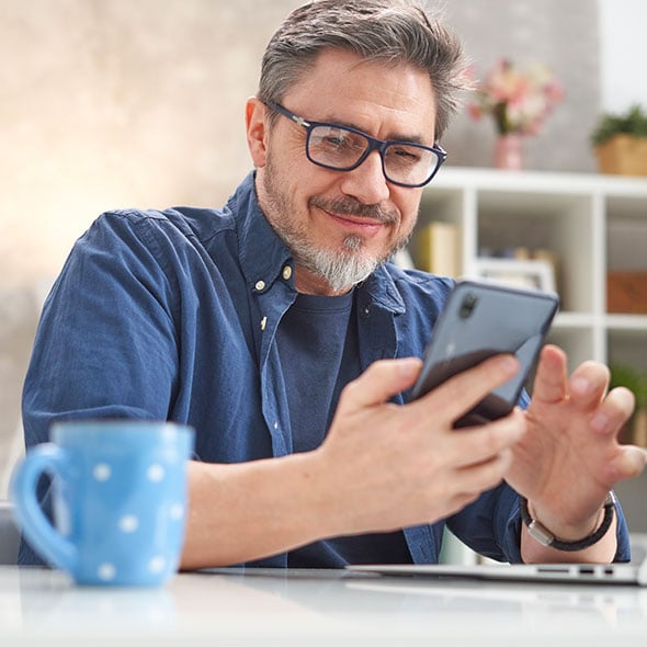 Man on the mobile banking app with PCU credit union in Portland Oregon.