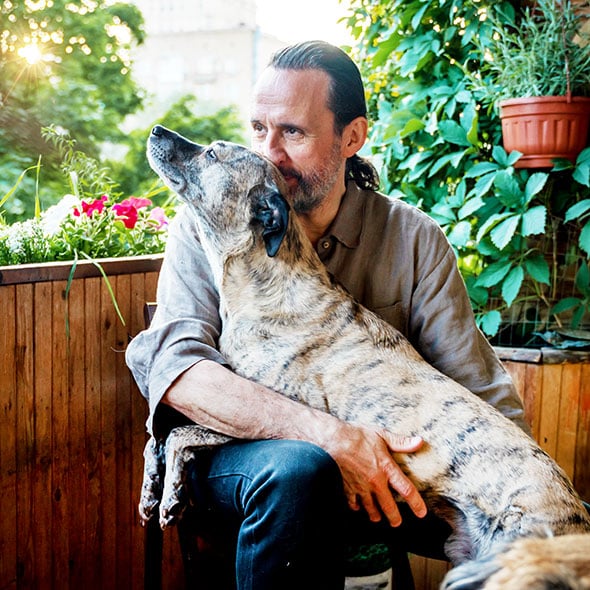Man with his dogs at home after purchasing new house with VA Loan from CCCU credit union in Portland Oregon