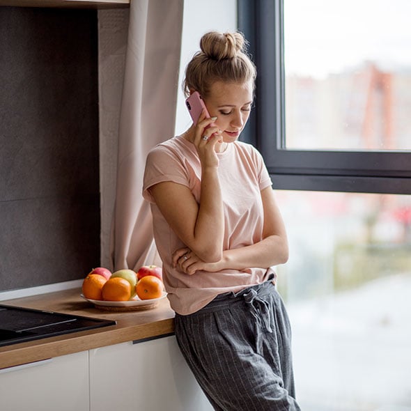 Serious woman talking on the phone to discuss a credit card dispute error.