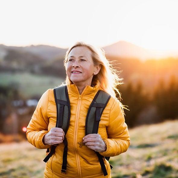 Middle aged woman hiking who has peace of mind because she has an IRA with Providence Credit Union Portland Credit Union.