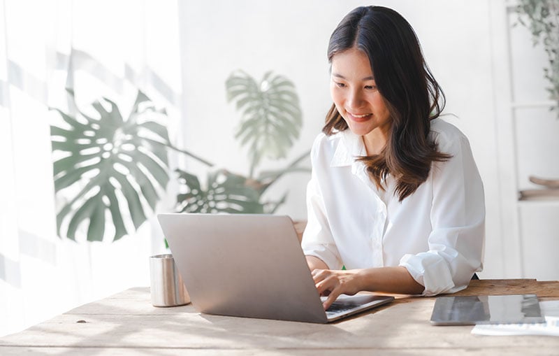 Woman on computer reading the CCCU newsletter.