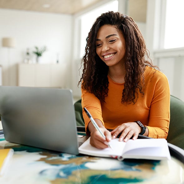 Woman checking her money market savings account on her computer at home.