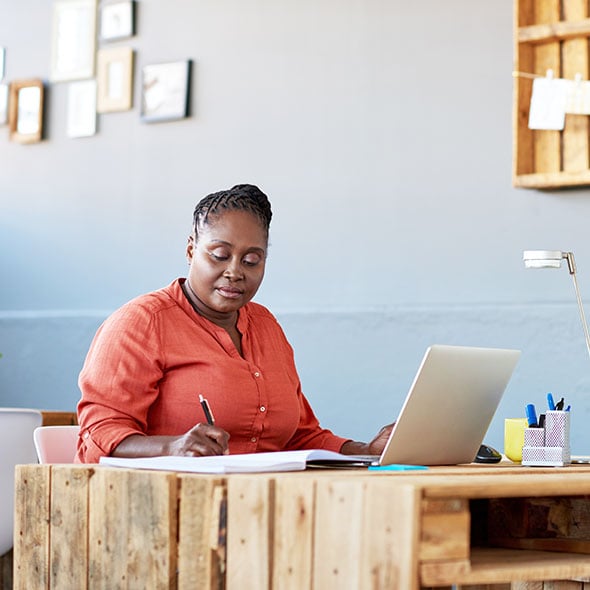 Woman filling out paperwork for a PCU sponsorship.