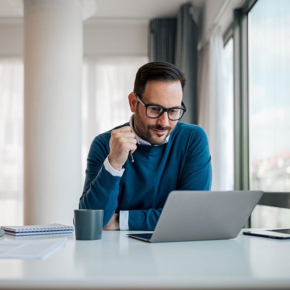 Concerned man on the computer reporting a lost or stolen card.