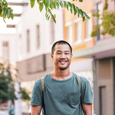 Young man in the city happy because he opened a PCU Savings Account